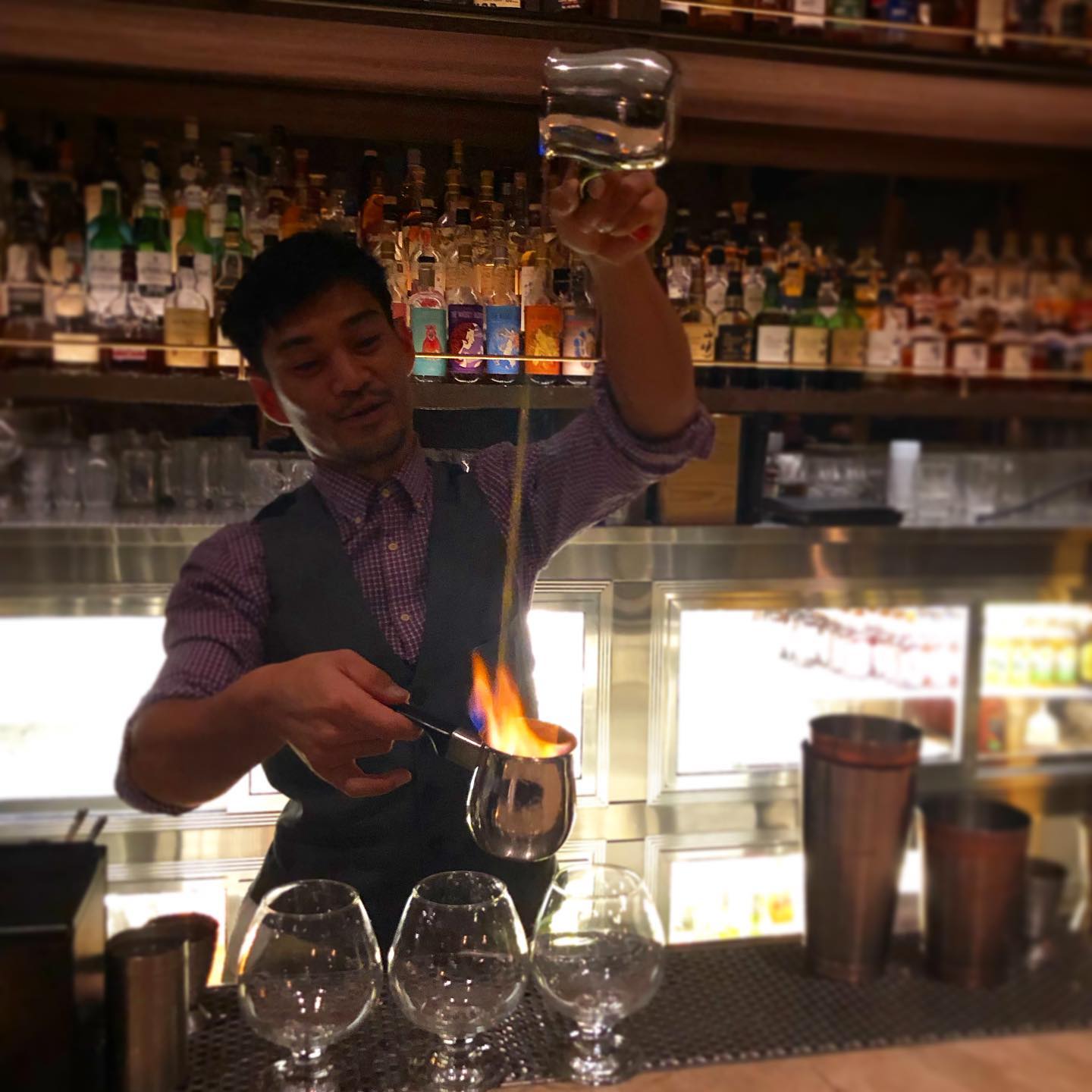 bartender making a flaming cocktail